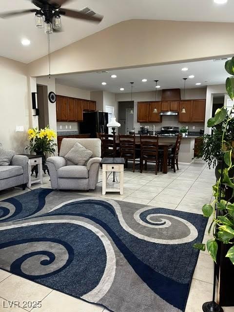 living room featuring lofted ceiling, light tile patterned flooring, and recessed lighting