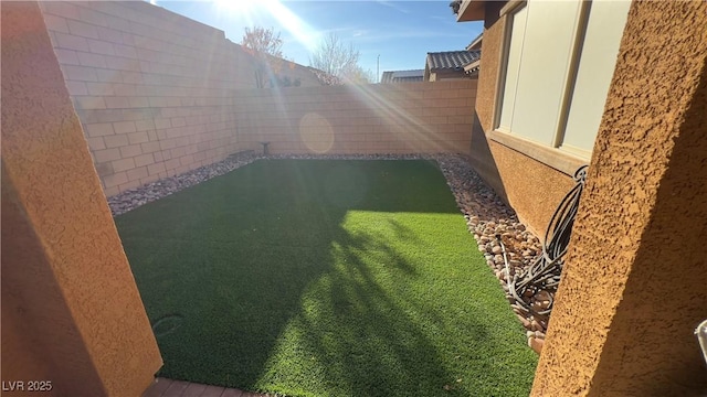 view of yard with a fenced backyard