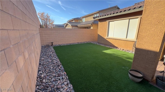 view of yard with a fenced backyard