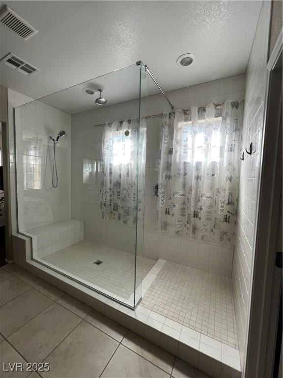 full bath featuring a stall shower, visible vents, and tile patterned floors