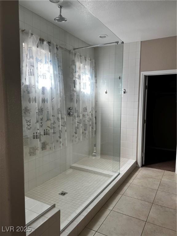 full bath featuring a stall shower and tile patterned floors