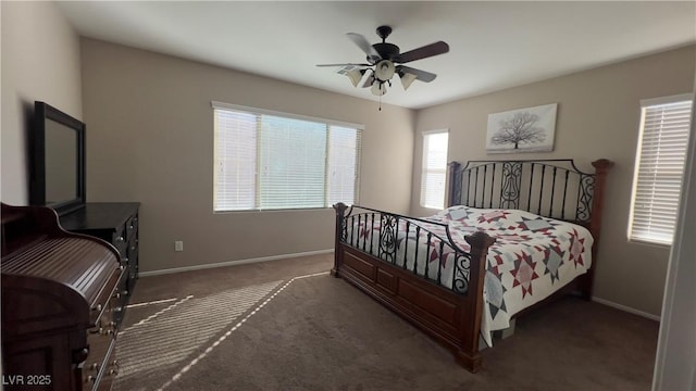 carpeted bedroom with a ceiling fan and baseboards