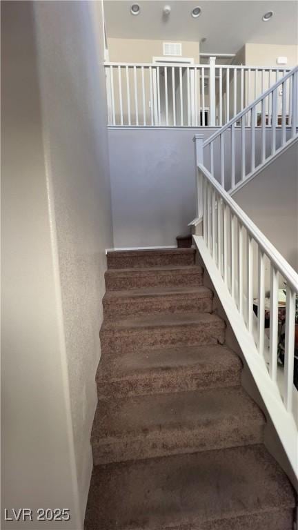 staircase featuring recessed lighting