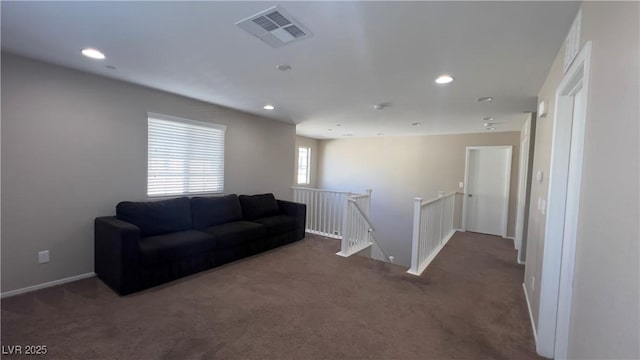 living room with visible vents, carpet flooring, and recessed lighting