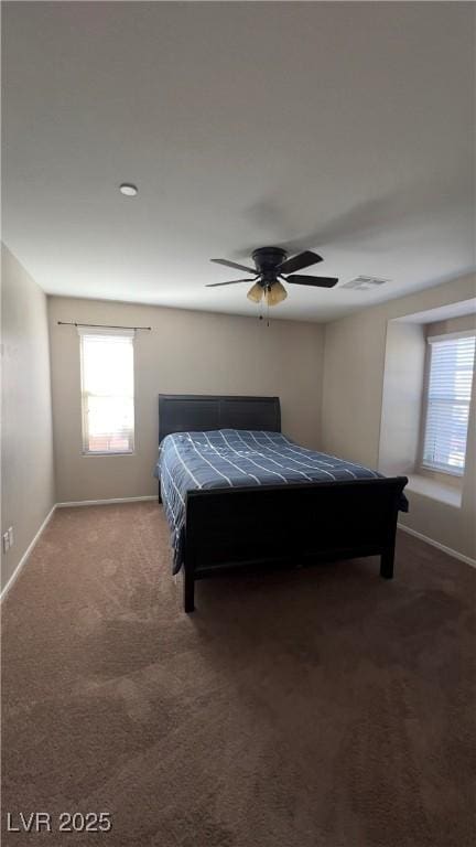 carpeted bedroom with baseboards, visible vents, and a ceiling fan