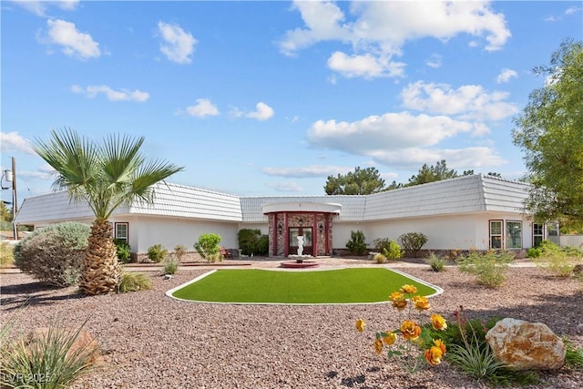 exterior space featuring a lawn and stucco siding