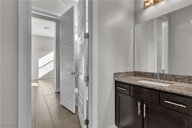 bathroom featuring tile patterned flooring, visible vents, vanity, and baseboards