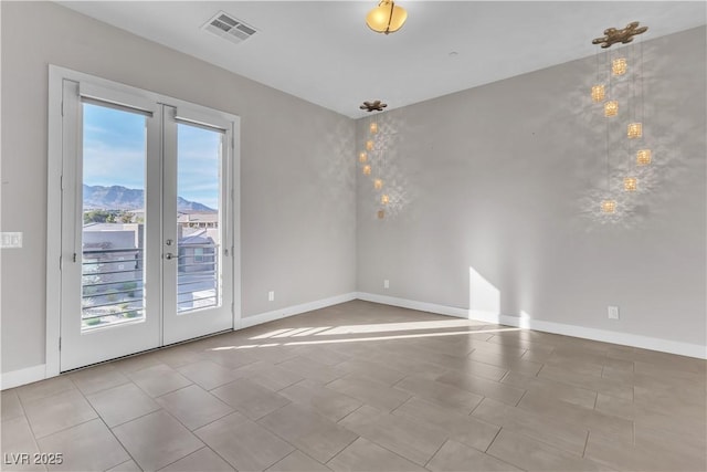 unfurnished room featuring french doors, visible vents, and baseboards