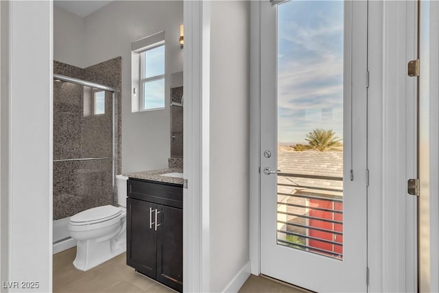 bathroom with a stall shower, vanity, and toilet