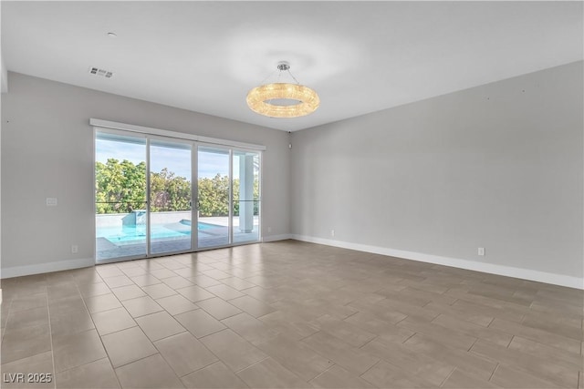 unfurnished room featuring visible vents and baseboards