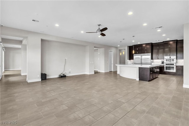 unfurnished living room with a ceiling fan, recessed lighting, and visible vents