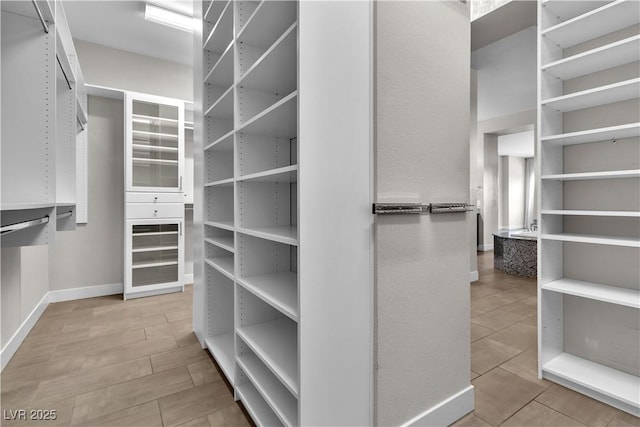 spacious closet with wood tiled floor