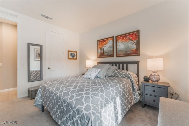 carpeted bedroom featuring visible vents