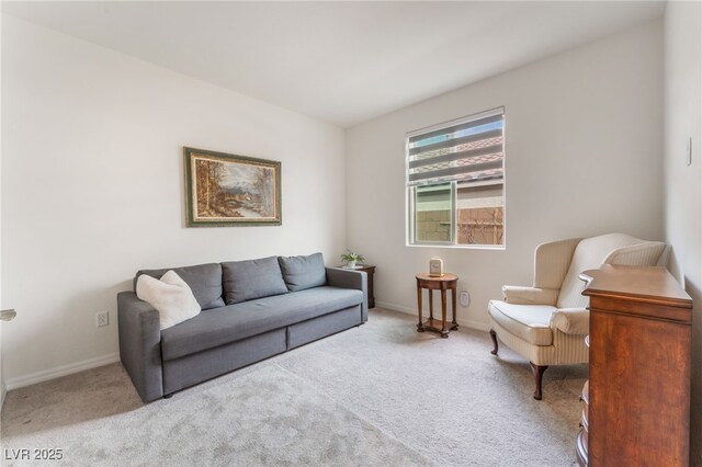 carpeted living area featuring baseboards