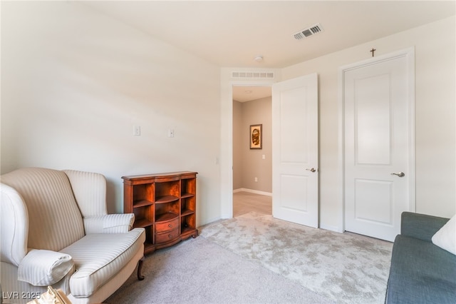 sitting room featuring carpet, visible vents, and baseboards