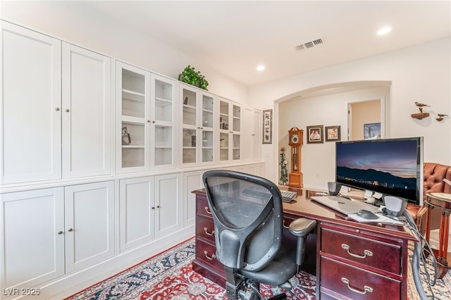 office with arched walkways, visible vents, and recessed lighting