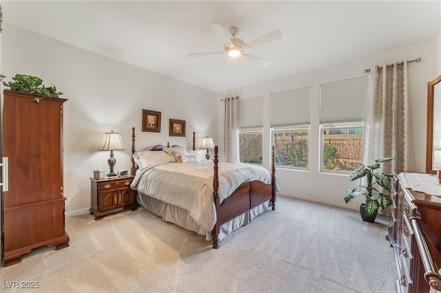 bedroom with light carpet and a ceiling fan