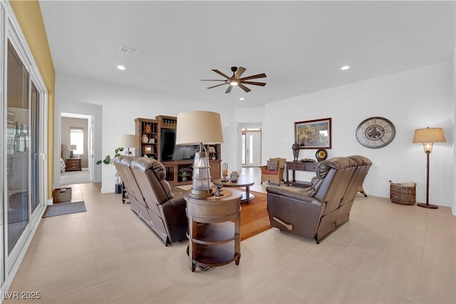 living room with a ceiling fan, recessed lighting, and visible vents