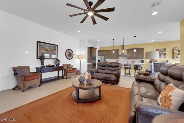 living room with light tile patterned floors, visible vents, a ceiling fan, and recessed lighting