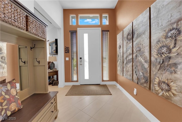 foyer with a high ceiling and baseboards