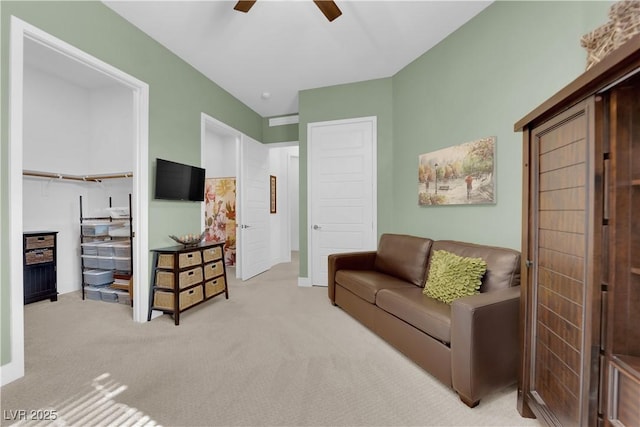 carpeted living area featuring a ceiling fan