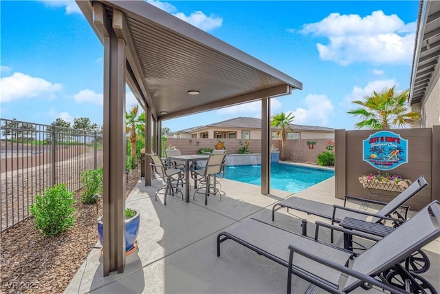 view of pool with a fenced in pool, a patio area, a fenced backyard, and outdoor dining area