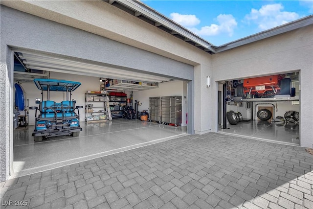 garage with decorative driveway