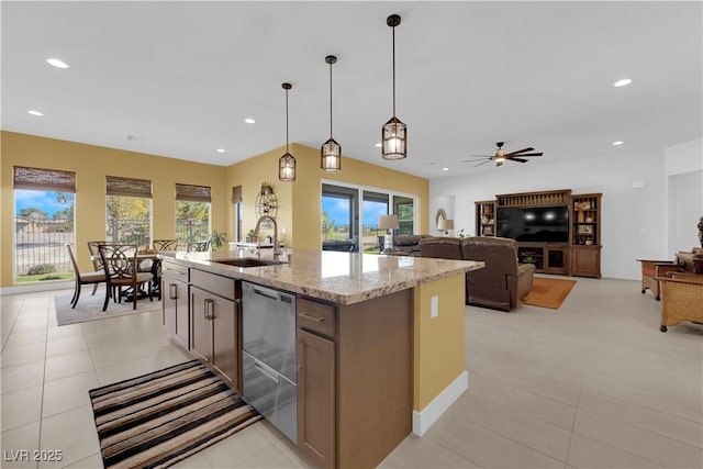 kitchen with stainless steel dishwasher, a wealth of natural light, a sink, and recessed lighting