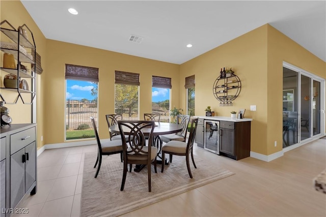 dining area featuring baseboards, wine cooler, visible vents, and recessed lighting