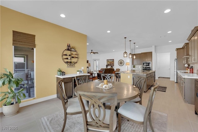 dining space featuring light tile patterned floors, baseboards, a ceiling fan, and recessed lighting