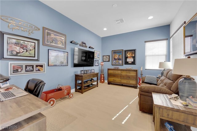 living area with baseboards, visible vents, and recessed lighting