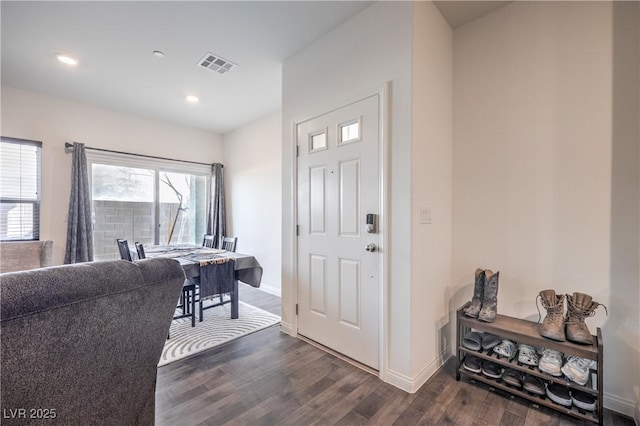 entryway featuring baseboards, visible vents, dark wood finished floors, and recessed lighting