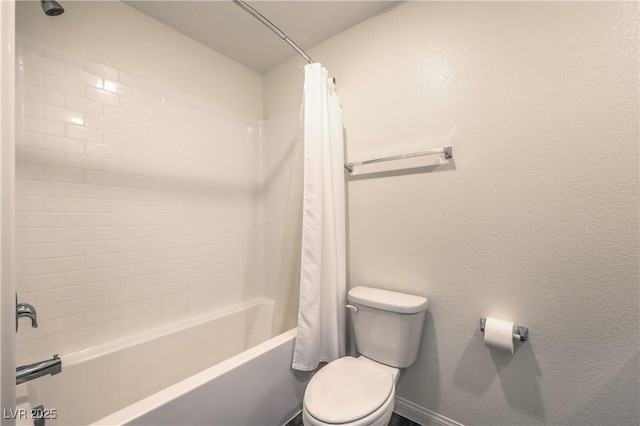 full bathroom with toilet, shower / tub combo, baseboards, and a textured wall