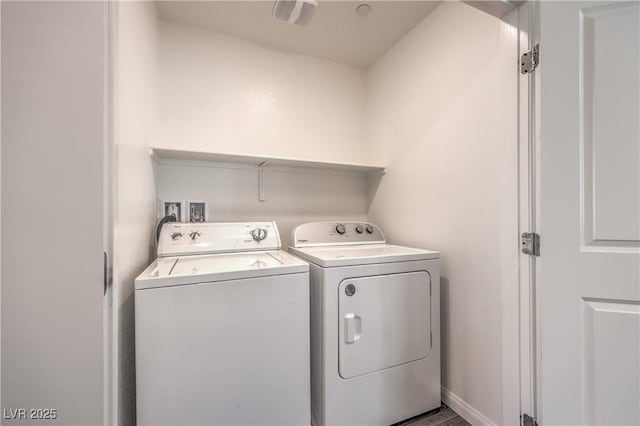 washroom with laundry area, separate washer and dryer, and visible vents