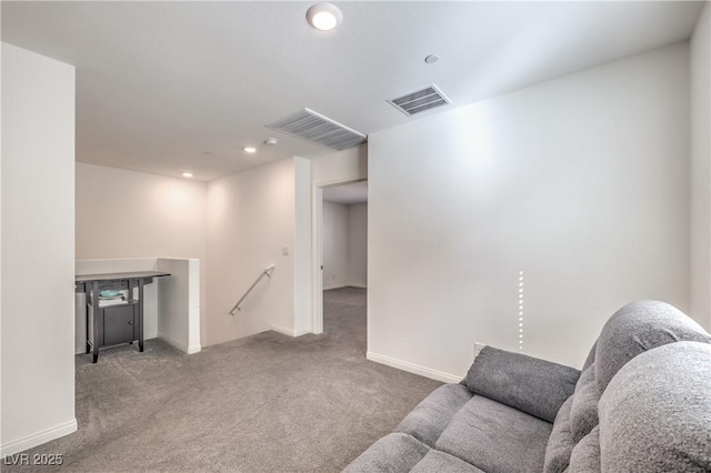 carpeted living area featuring recessed lighting, visible vents, and baseboards