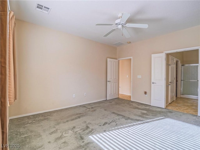 unfurnished bedroom featuring ceiling fan, carpet, visible vents, and baseboards