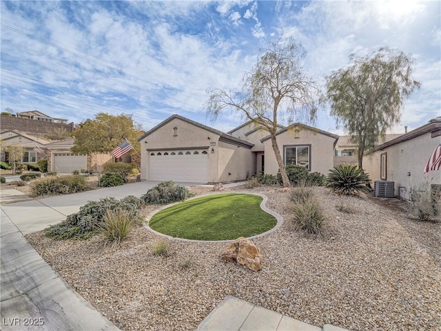 mediterranean / spanish-style house with driveway, central AC unit, an attached garage, and stucco siding