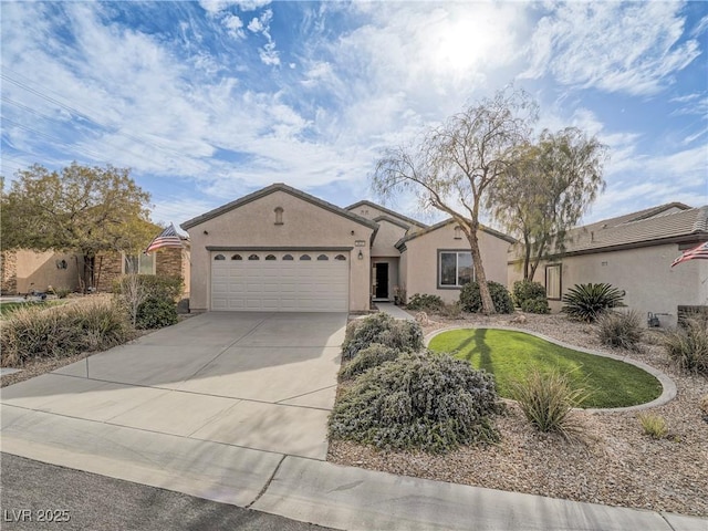 view of front facade featuring concrete driveway, an attached garage, and stucco siding