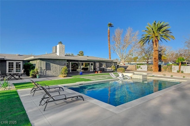 view of pool with a patio area and fence