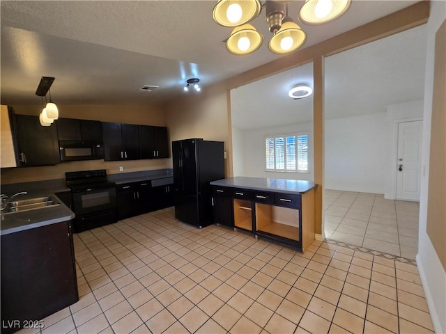 kitchen with light tile patterned flooring, dark cabinets, a sink, vaulted ceiling, and black appliances