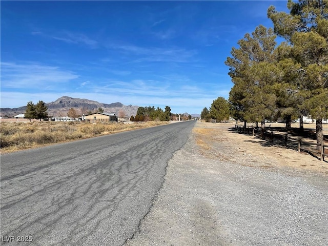 view of street with a rural view and a mountain view