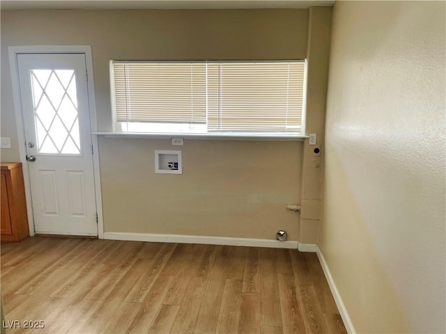 washroom with baseboards, laundry area, hookup for a washing machine, and light wood-style floors