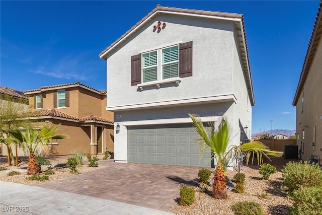 view of front of property with a garage, decorative driveway, and stucco siding