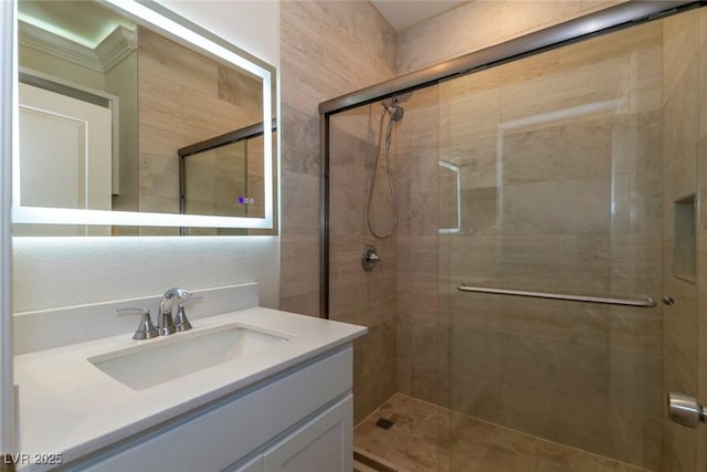 bathroom featuring a shower stall and vanity