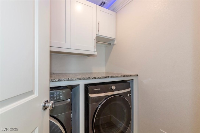 laundry area featuring independent washer and dryer and cabinet space