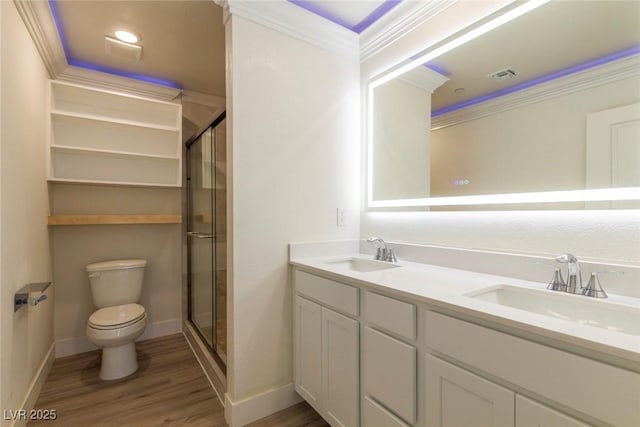 full bath with a stall shower, crown molding, a sink, and wood finished floors