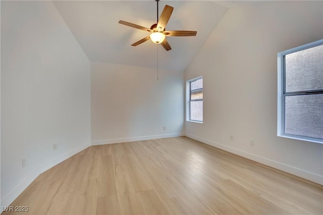 spare room featuring a ceiling fan, baseboards, high vaulted ceiling, and light wood finished floors