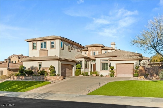 prairie-style house featuring a garage, aphalt driveway, a front yard, and stucco siding