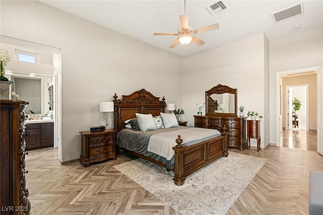 bedroom featuring baseboards, visible vents, and ensuite bathroom