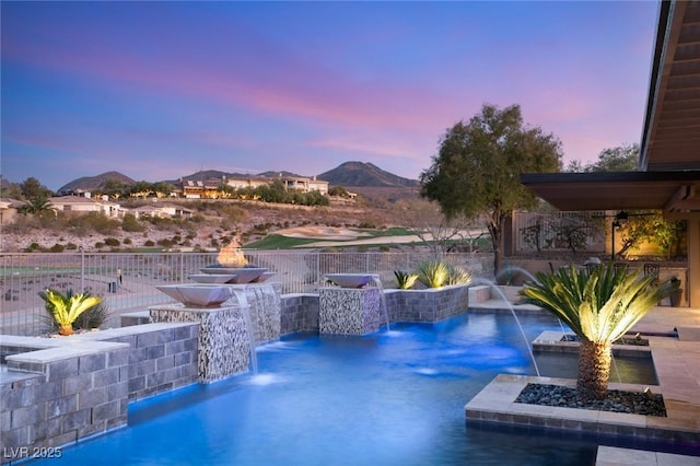 view of pool featuring fence and a mountain view